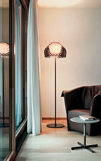 Stylized ambient lighting fixture in a modern interior setting with the words Ambient Lighting displayed in white text on a dark blue background evoking a calm and sophisticated atmosphere